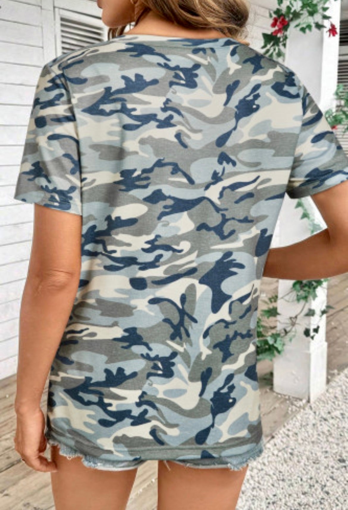 Person wearing a camouflage dress with a neutral background
