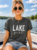 Woman wearing a 'Lake girl' t-shirt on a boat with a lake background