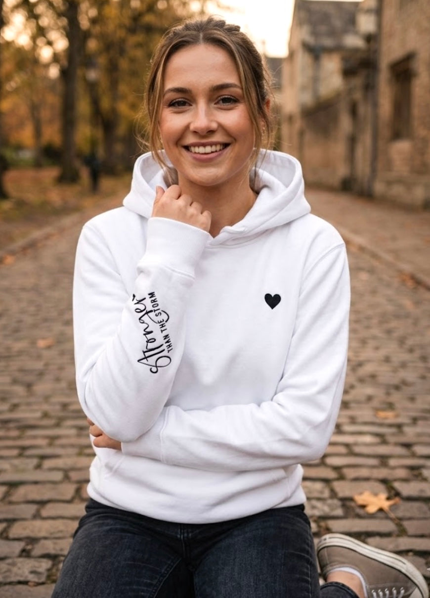 White Hoodie with black heart and Stronger than the Storm on sleeve