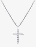 A silver cross pendant necklace paved with small clear stones, hanging from a silver cable chain against a light gray background.