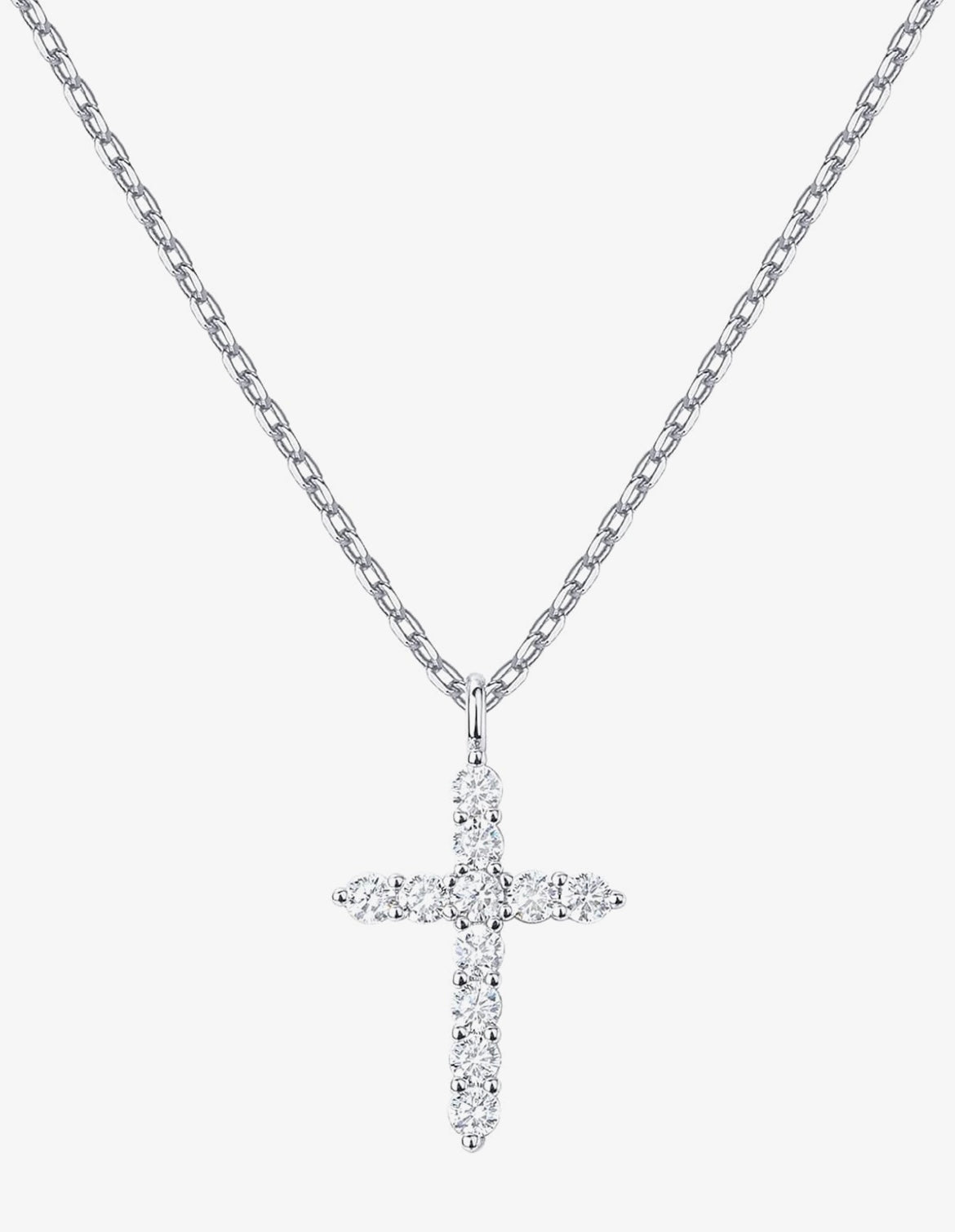 A silver cross pendant necklace paved with small clear stones, hanging from a silver cable chain against a light gray background.