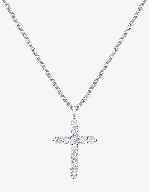 A silver cross pendant necklace paved with small clear stones, hanging from a silver cable chain against a light gray background.