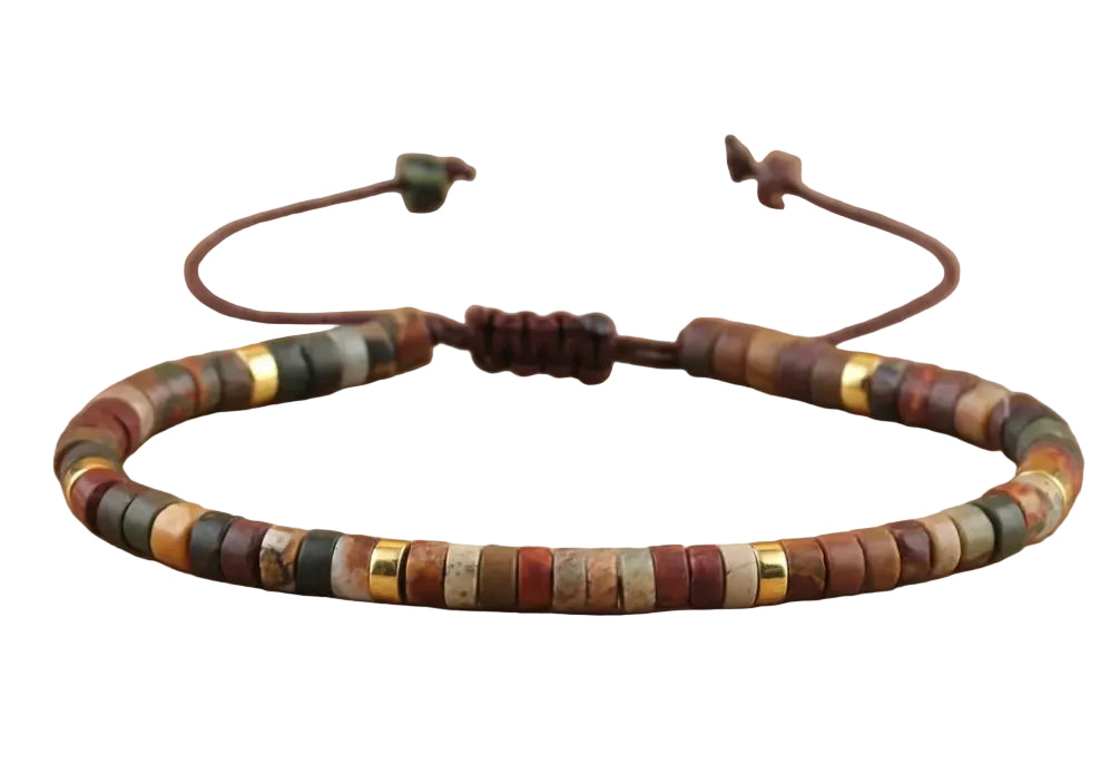A beaded bracelet made of small round stone beads in earthy brown, beige, gray, and muted green tones, with a dark brown adjustable cord and gold-tone spacer accents, displayed on a white background.