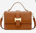 A structured brown leather handbag with a top handle, a detachable shoulder strap, and a gold-tone metal clasp on the front flap, shown against a plain white background.