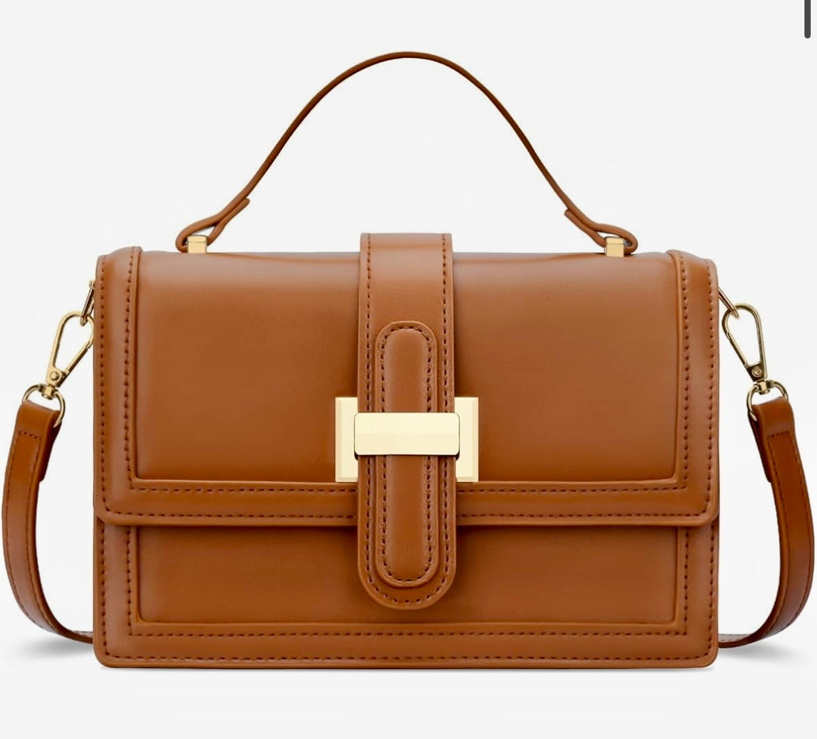 A structured brown leather handbag with a top handle, a detachable shoulder strap, and a gold-tone metal clasp on the front flap, shown against a plain white background.