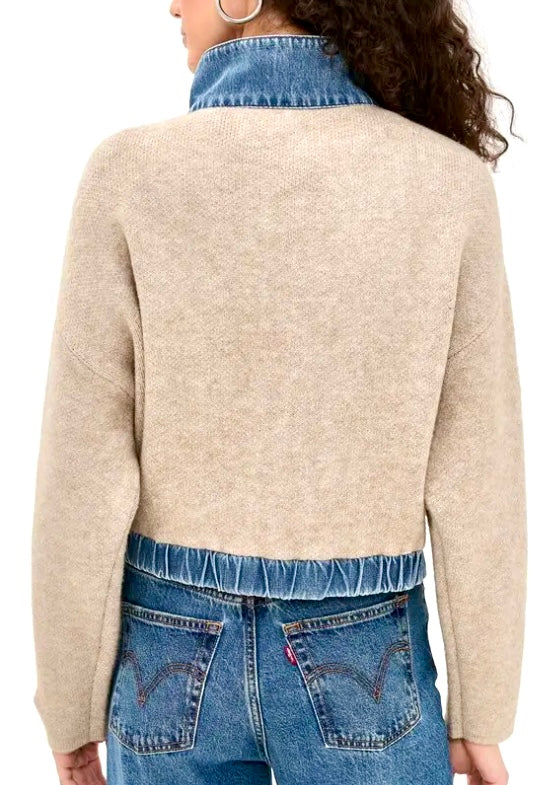 A person shown from the back wearing a cropped knit sweater with a high blue denim collar and blue jeans against a plain white background.