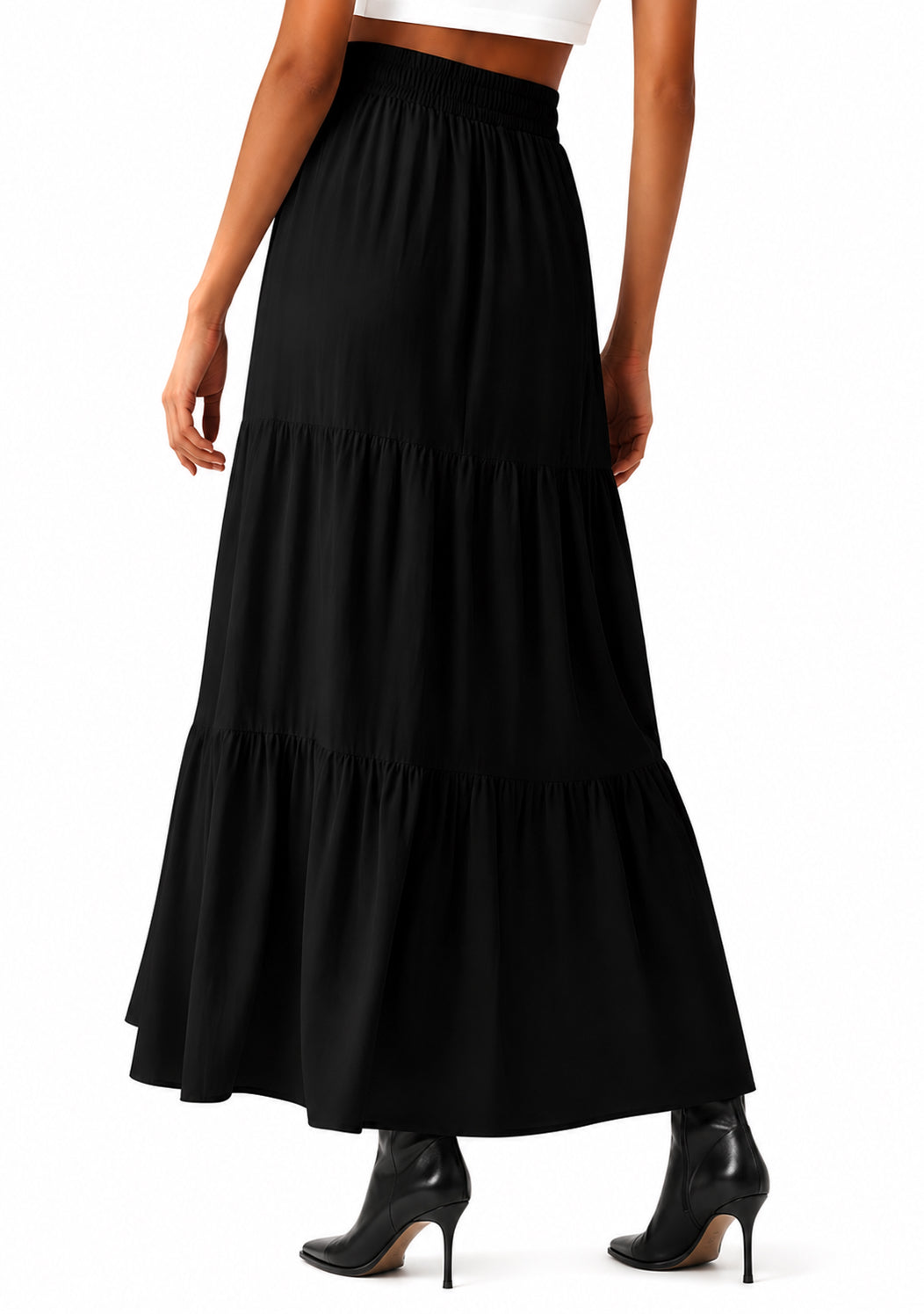 A model wearing a long black tiered maxi skirt with an elastic waistband, paired with black ankle boots, shown from the waist down on a white background.