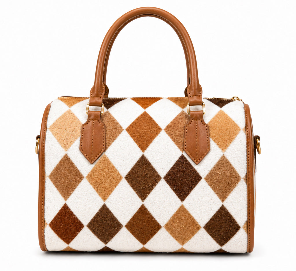 A structured handbag with a brown and white argyle pattern made of textured animal hair, finished with smooth brown leather handles and trim.