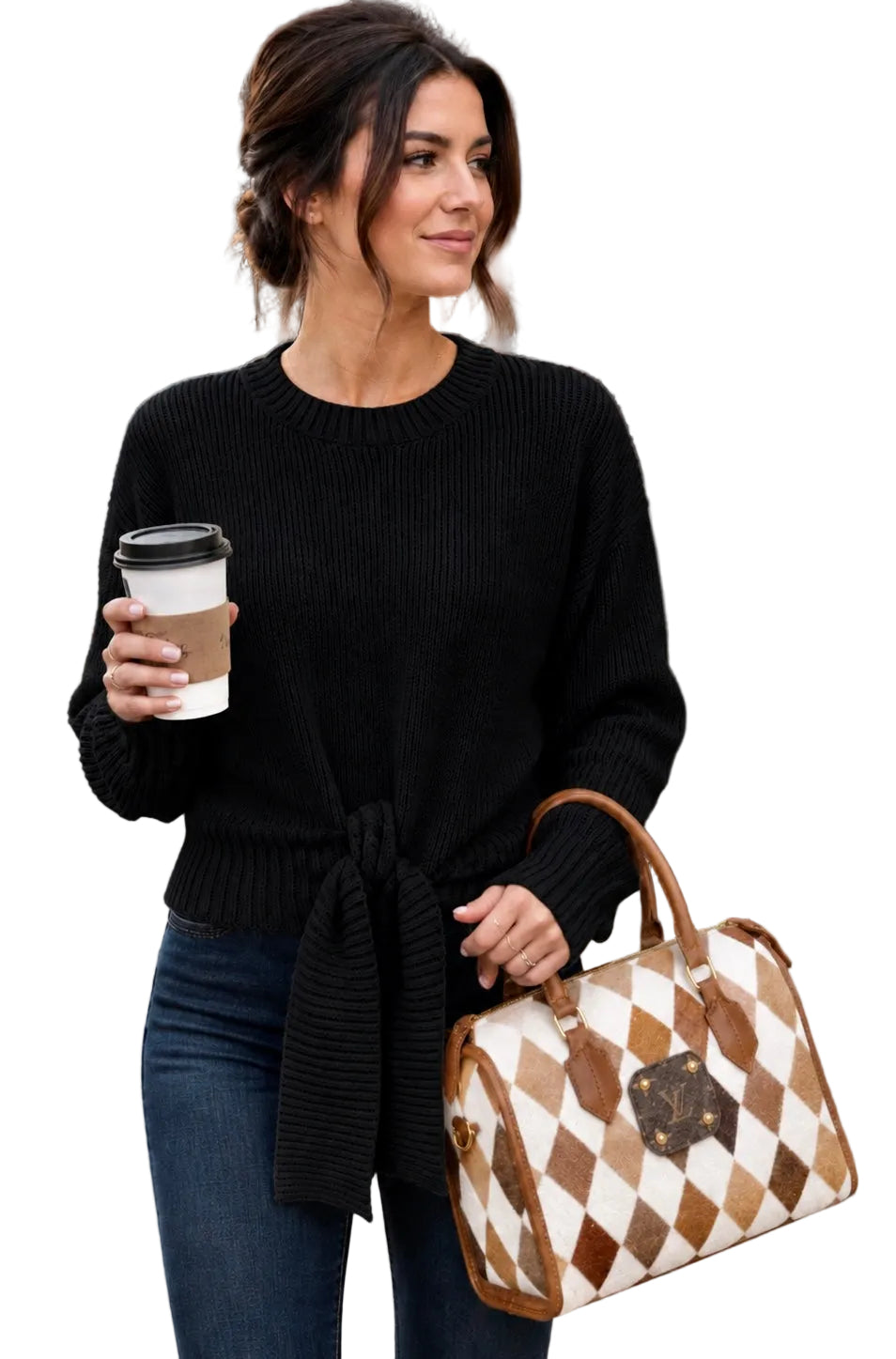 A woman wearing a black ribbed knit sweater and blue jeans holding a brown and white checkered Louis Vuitton duffel bag and a coffee cup.