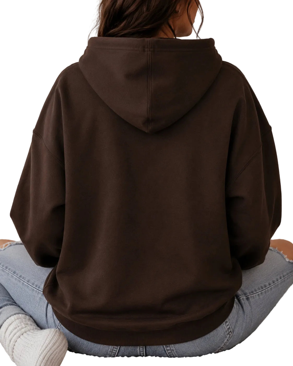 A person viewed from behind wearing an oversized dark brown hoodie, light blue jeans, and white knit socks while sitting with a white background.