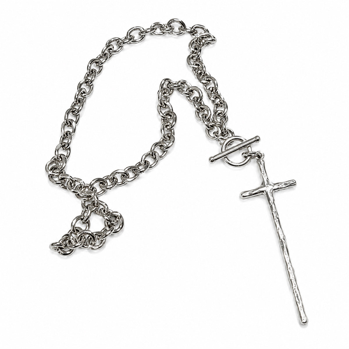 A silver-toned chain necklace featuring a textured cross pendant, a toggle clasp, and a small heart-shaped charm, displayed on a clean white background.