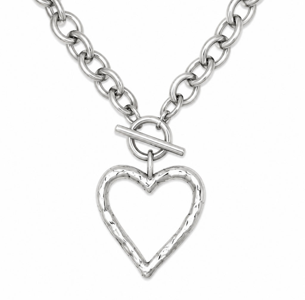 A silver chain necklace featuring a textured, open heart-shaped pendant with a toggle clasp, shown against a plain white background.