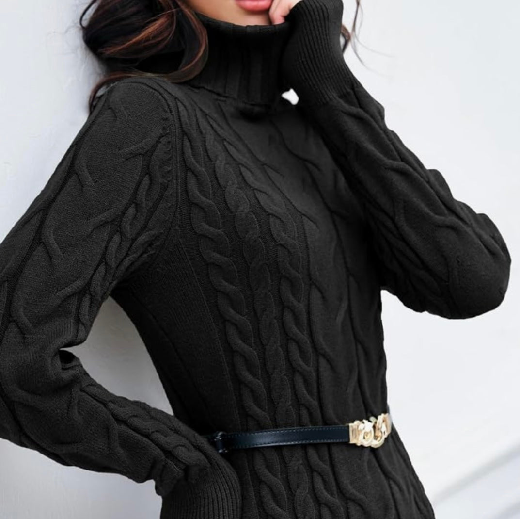 A close-up of a woman wearing a black cable-knit turtleneck sweater with a black belt featuring a gold-tone decorative buckle.