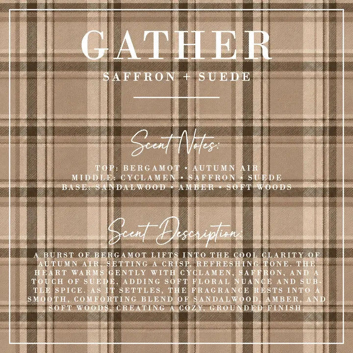 A square scent card with a beige and brown plaid pattern background, featuring white text that reads 'GATHER' and 'SAFFRON + SUEDE' with scent notes and a detailed scent description.